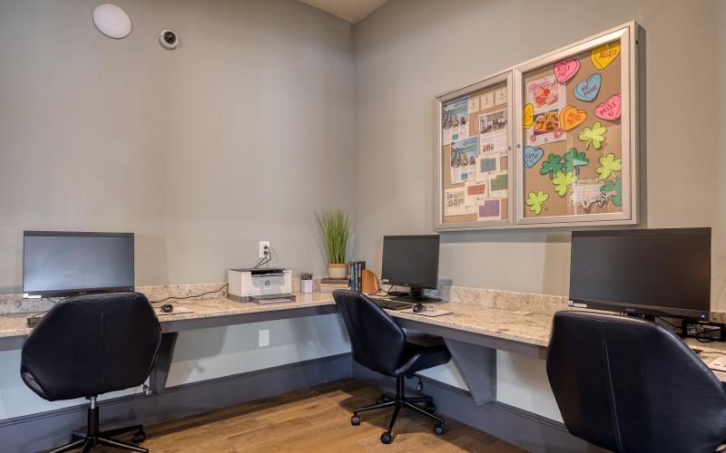 an office with a large desk and chairs
